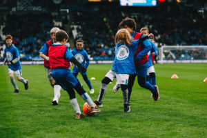 Kids partake in a football drill